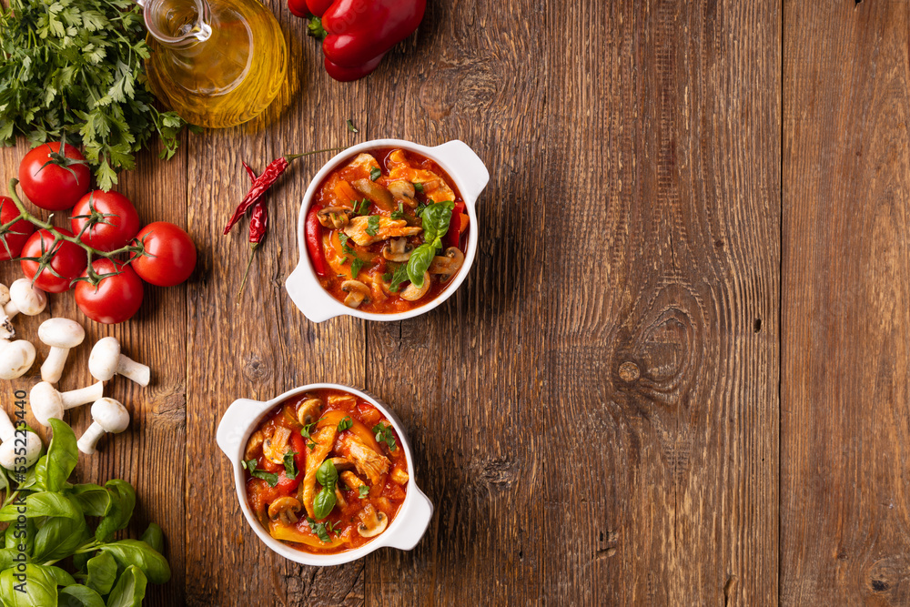 Chicken stew with peppers, mushrooms and tomatoes. Chicken stew with peppers, mushrooms and tomatoes.