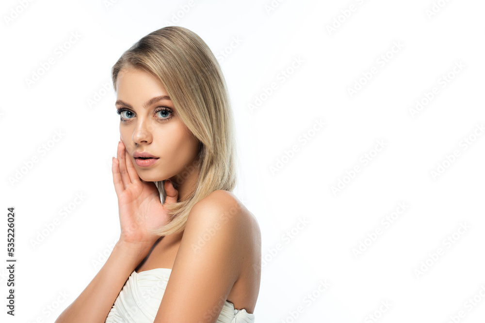 blonde model with bare shoulders and blue eyes looking at camera isolated on white. blonde model with bare shoulders and blue eyes looking at camera isolated on white.