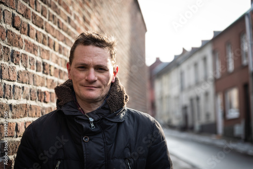 Portrait of a forty year old man posing in the streets of old town in witer photo