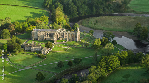 Early morning sunshine illuminates Bolton Abbey in Wharfedale, North Yorkshire, England, takes its name from the ruins of the 12th-century Augustinian monastery now known as Bolton Priory