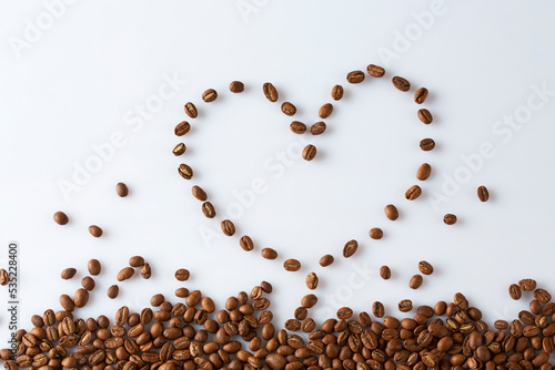 coffee beans scattered in the shape of a heart on a white background