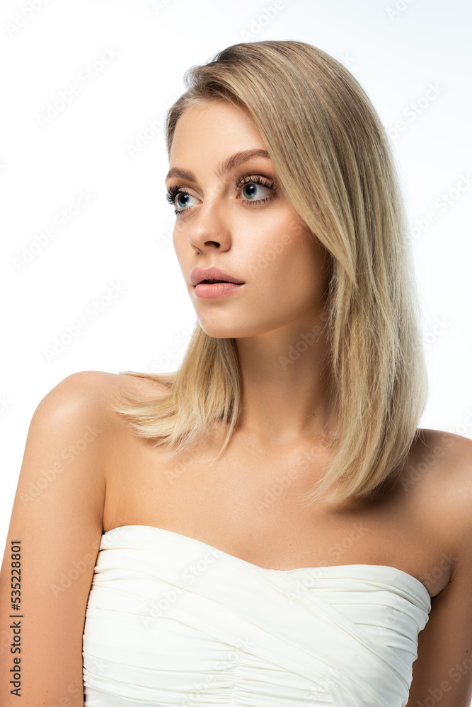 portrait of blonde woman with bare shoulders and natural makeup isolated on white.