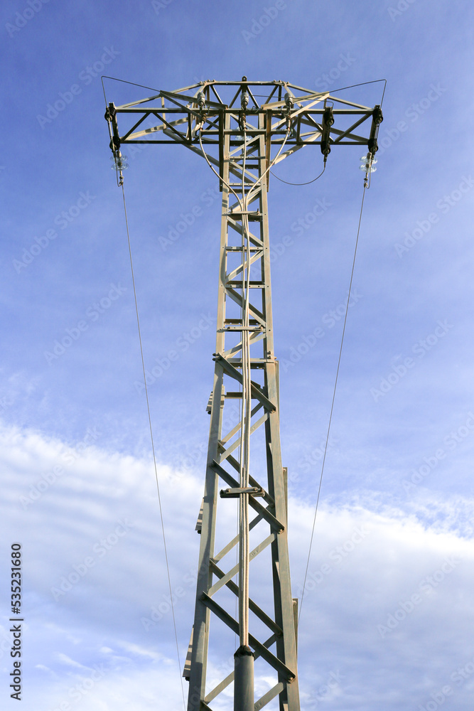Power lines tower under blue sky in the countryside Power lines tower under blue sky in the countryside