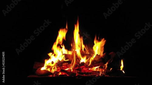 Flames of fire on a black background. Bonfire in the camp.
