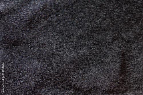 Dark brown cracked leather texture background