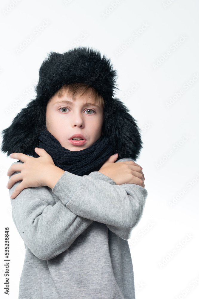 Portrait of a boy on a white background in a hat with ears and a scarf. Portrait of a boy on a white background in a hat with ears and a scarf.