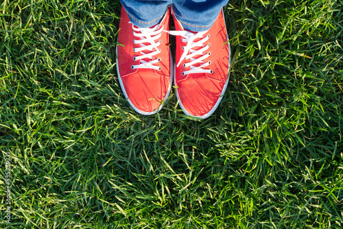 Top view of red sneakers on green grass. copy space © kravik93