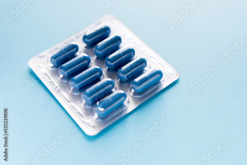  blister with pills on a blue background. Model special offers as advertising, web background or other ideas. The concept of medicine, pharmacy and healthcare. copyright.
