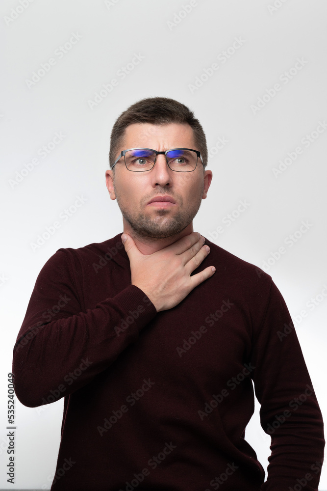 Handsome man wearing glasses over isolated background touching painful neck, sore throat from flu, cold and infection Handsome man wearing glasses over isolated background touching painful neck, sore throat from flu, cold and infection