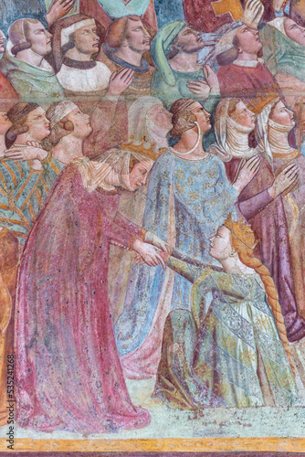 Detail of medieval fresco showing princess kneeling before queen in the medieval court of Pisa