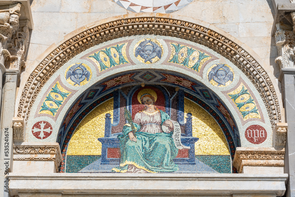 Religious fresco under arch on exterior facade of catholic basilica in Pisa