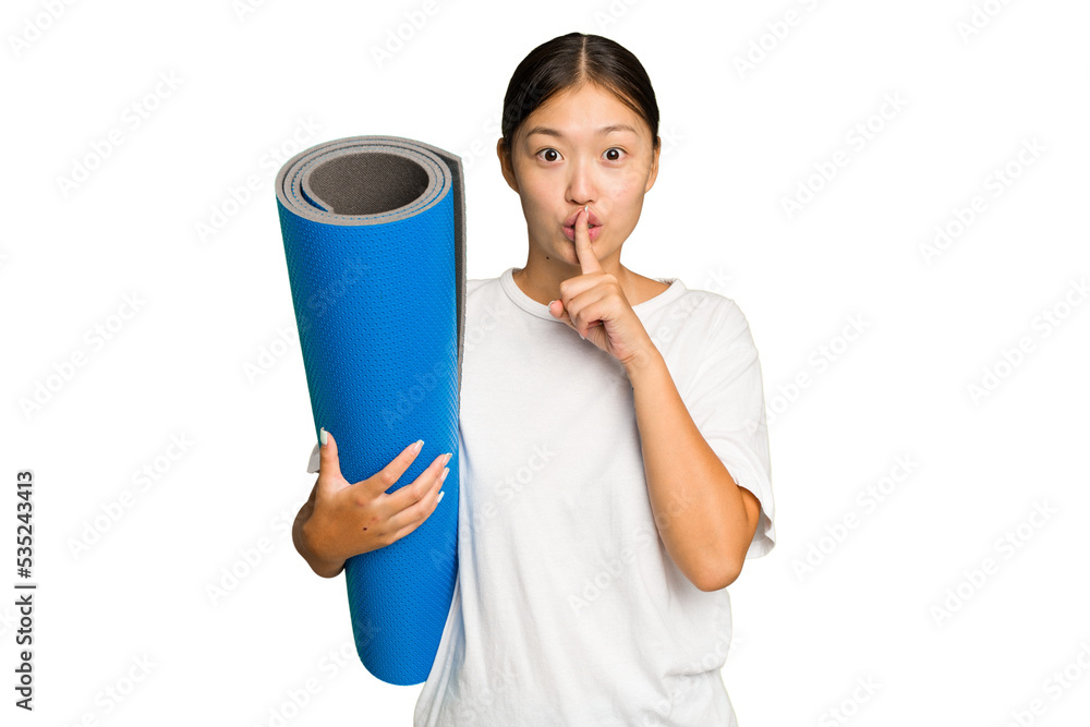 Young asian woman holding a mat isolated on green chroma background keeping a secret or asking for silence. Young asian woman holding a mat isolated on green chroma background keeping a secret or asking for silence.