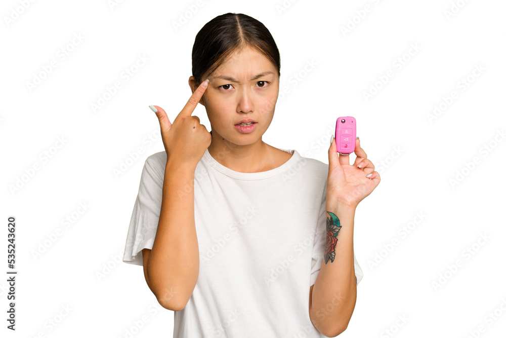 Young asian woman holding car keys isolated on green chroma background showing a disappointment gesture with forefinger. Young asian woman holding car keys isolated on green chroma background showing a disappointment gesture with forefinger.