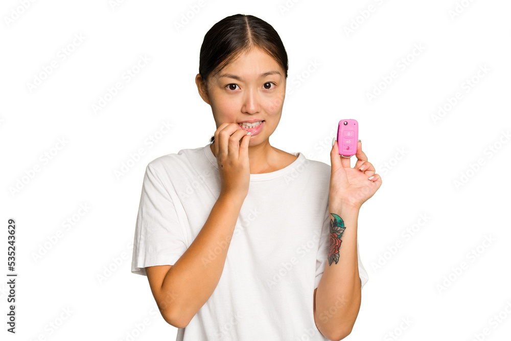 Young asian woman holding car keys isolated on green chroma background biting fingernails, nervous and very anxious. Young asian woman holding car keys isolated on green chroma background biting fingernails, nervous and very anxious.
