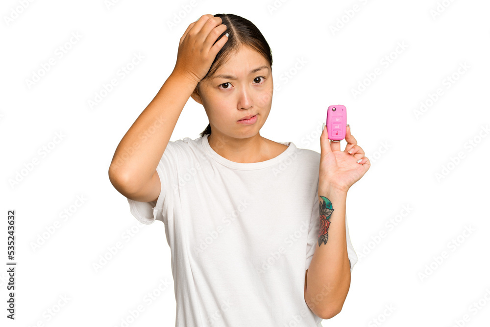 Young asian woman holding car keys isolated on green chroma background being shocked, she has remembered important meeting. Young asian woman holding car keys isolated on green chroma background being shocked, she has remembered important meeting.