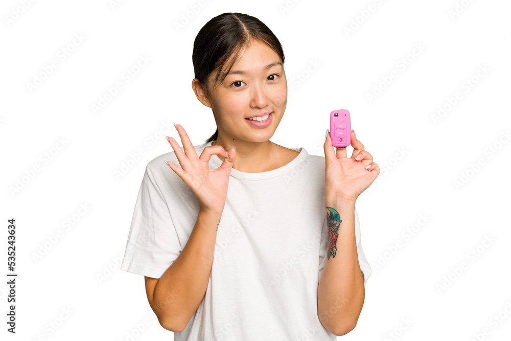 Young asian woman holding car keys isolated on green chroma background cheerful and confident showing ok gesture. Young asian woman holding car keys isolated on green chroma background cheerful and confident showing ok gesture.