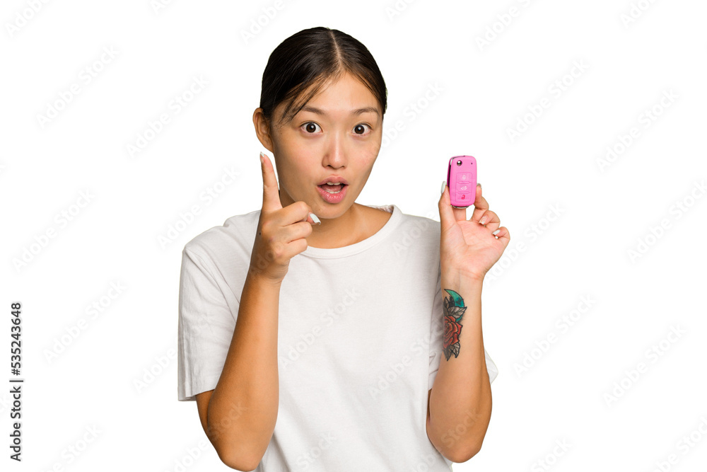 Young asian woman holding car keys isolated on green chroma background having an idea, inspiration concept. Young asian woman holding car keys isolated on green chroma background having an idea, inspiration concept.