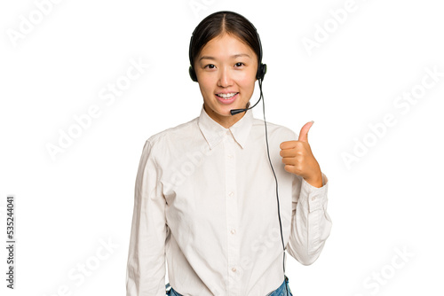 Фотография Telemarketer asian woman working with a headset isolated on green chroma backgro