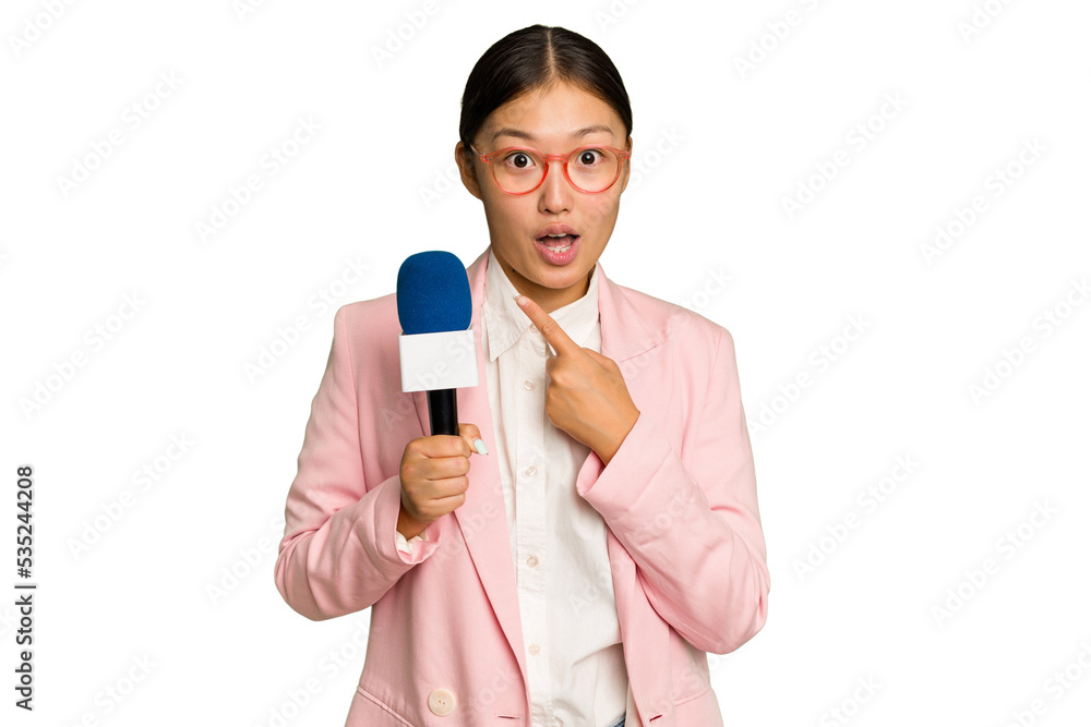 Young TV Asian presenter isolated on green chroma background pointing to the side Young TV Asian presenter isolated on green chroma background pointing to the side