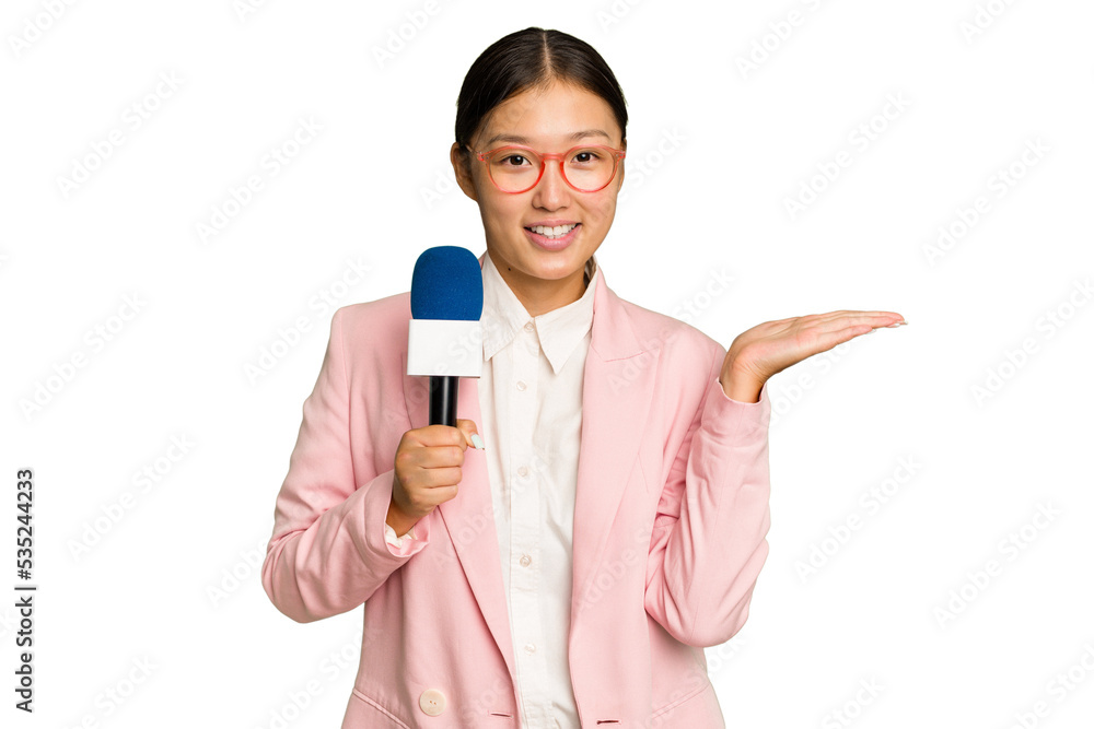 Young TV Asian presenter isolated on green chroma background showing a copy space on a palm and holding another hand on waist. Young TV Asian presenter isolated on green chroma background showing a copy space on a palm and holding another hand on waist.