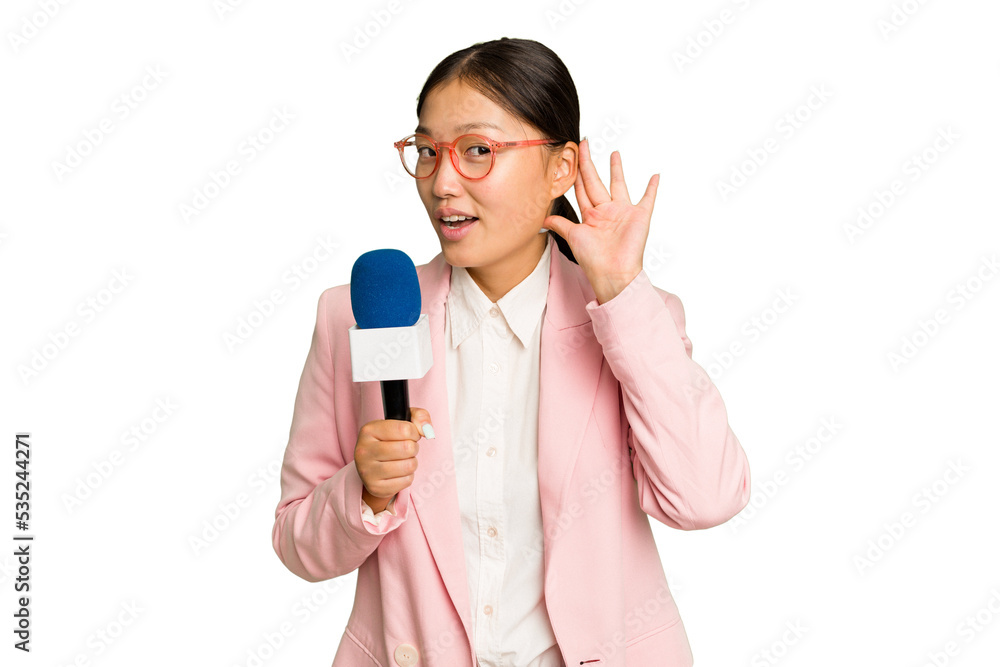 Young TV Asian presenter isolated on green chroma background trying to listening a gossip. Young TV Asian presenter isolated on green chroma background trying to listening a gossip.