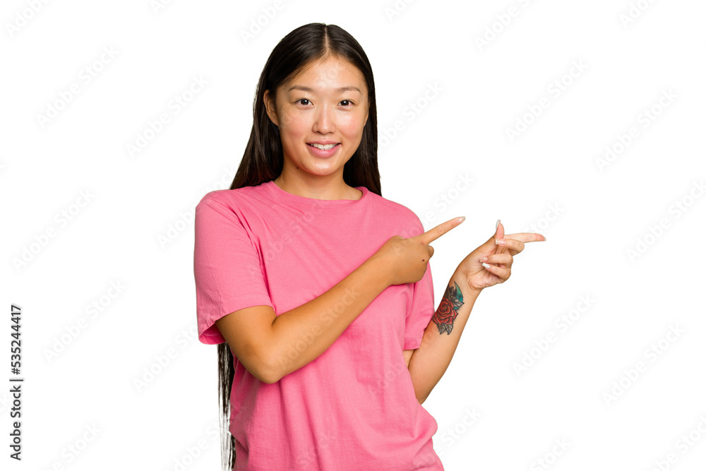 Young Asian woman isolated on green chroma background excited pointing with forefingers away. Young Asian woman isolated on green chroma background excited pointing with forefingers away.