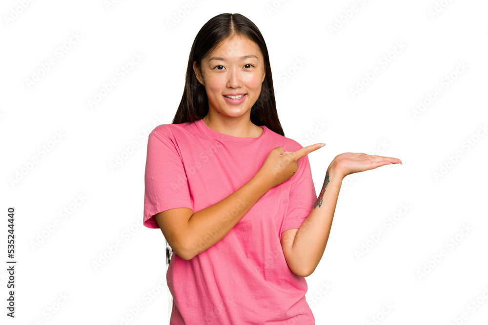 Young Asian woman isolated on green chroma background excited holding a copy space on palm. Young Asian woman isolated on green chroma background excited holding a copy space on palm.