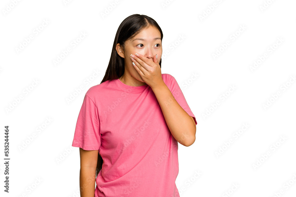 Young Asian woman isolated on green chroma background thoughtful looking to a copy space covering mouth with hand. Young Asian woman isolated on green chroma background thoughtful looking to a copy space covering mouth with hand.