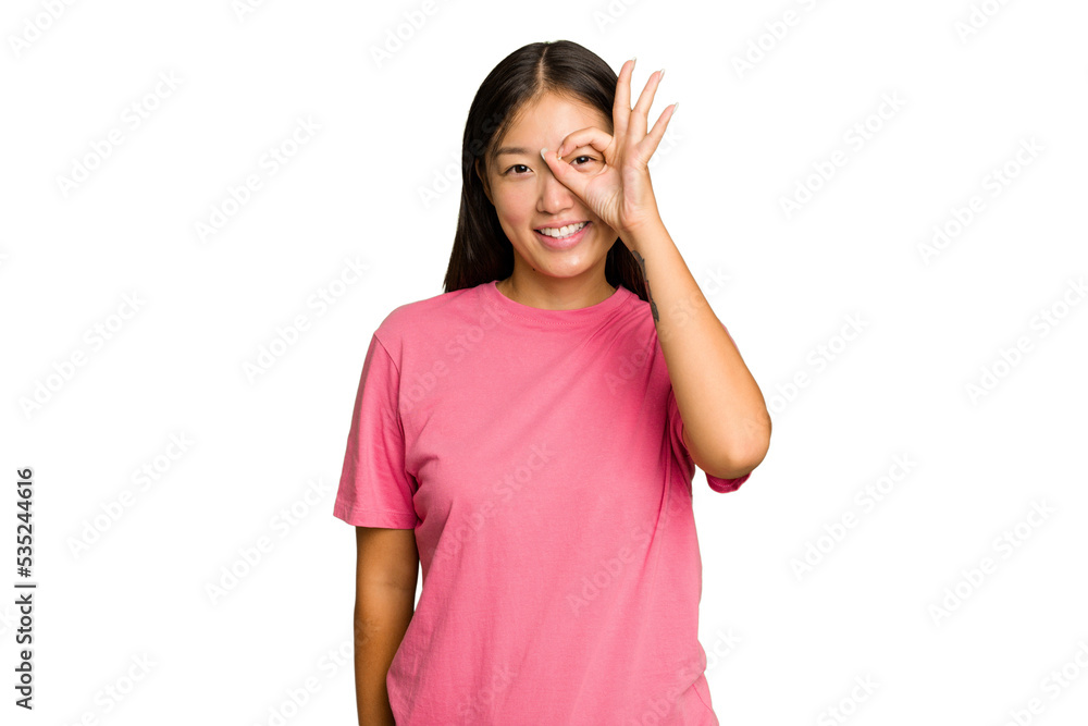 Young Asian woman isolated on green chroma background excited keeping ok gesture on eye. Young Asian woman isolated on green chroma background excited keeping ok gesture on eye.