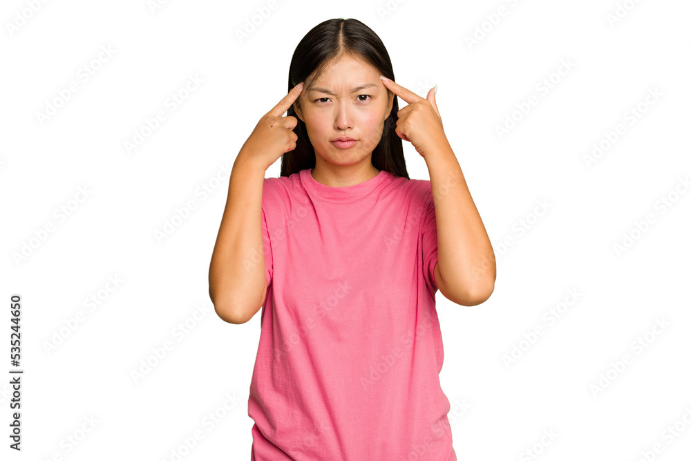 Young Asian woman isolated on green chroma background focused on a task, keeping forefingers pointing head. Young Asian woman isolated on green chroma background focused on a task, keeping forefingers pointing head.