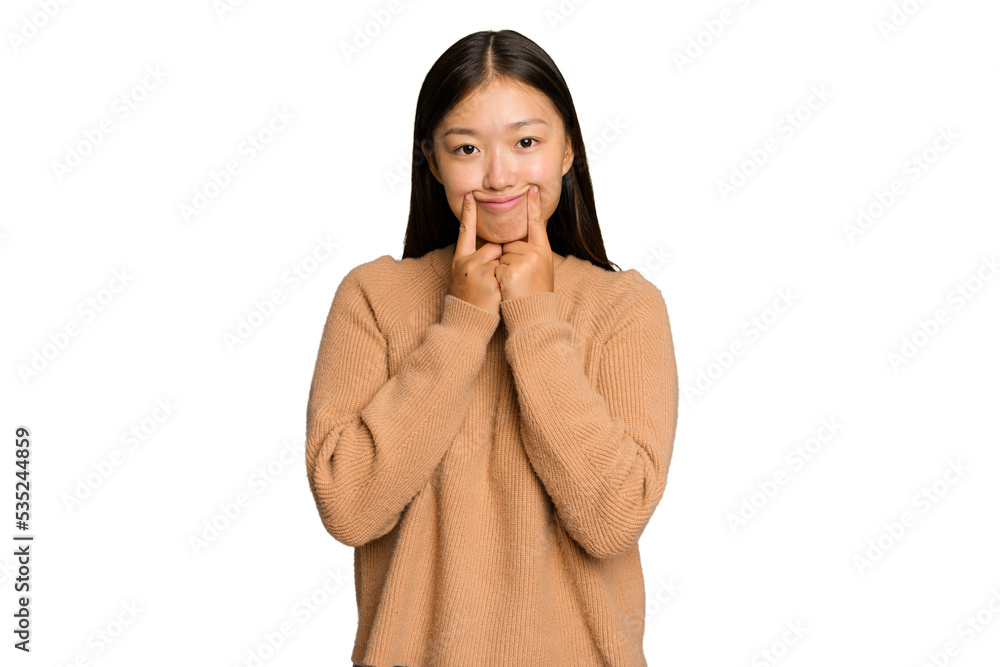 Young Asian woman isolated on green chroma background doubting between two options.