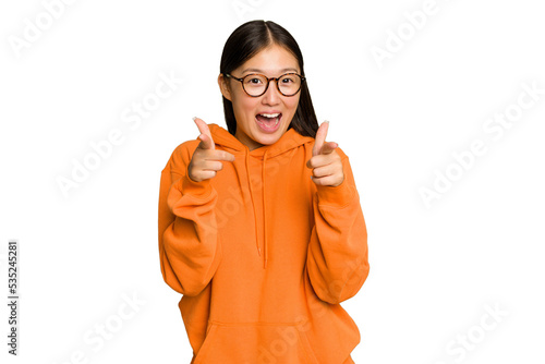Young Asian woman isolated on green chroma background cheerful smiles pointing to front.