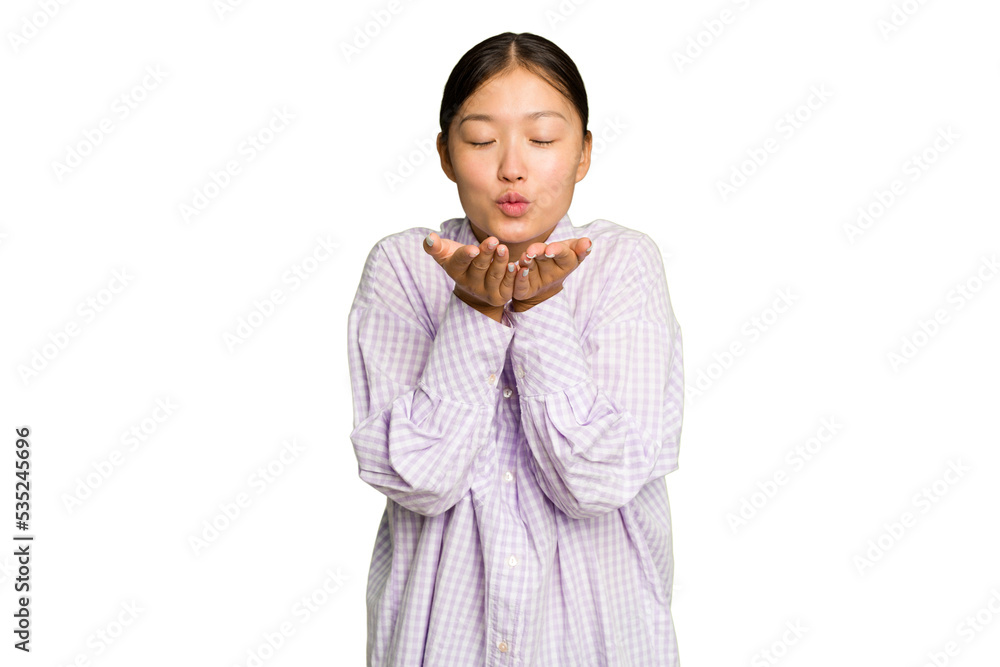 Young Asian woman isolated on green chroma background folding lips and holding palms to send air kiss. Young Asian woman isolated on green chroma background folding lips and holding palms to send air kiss.