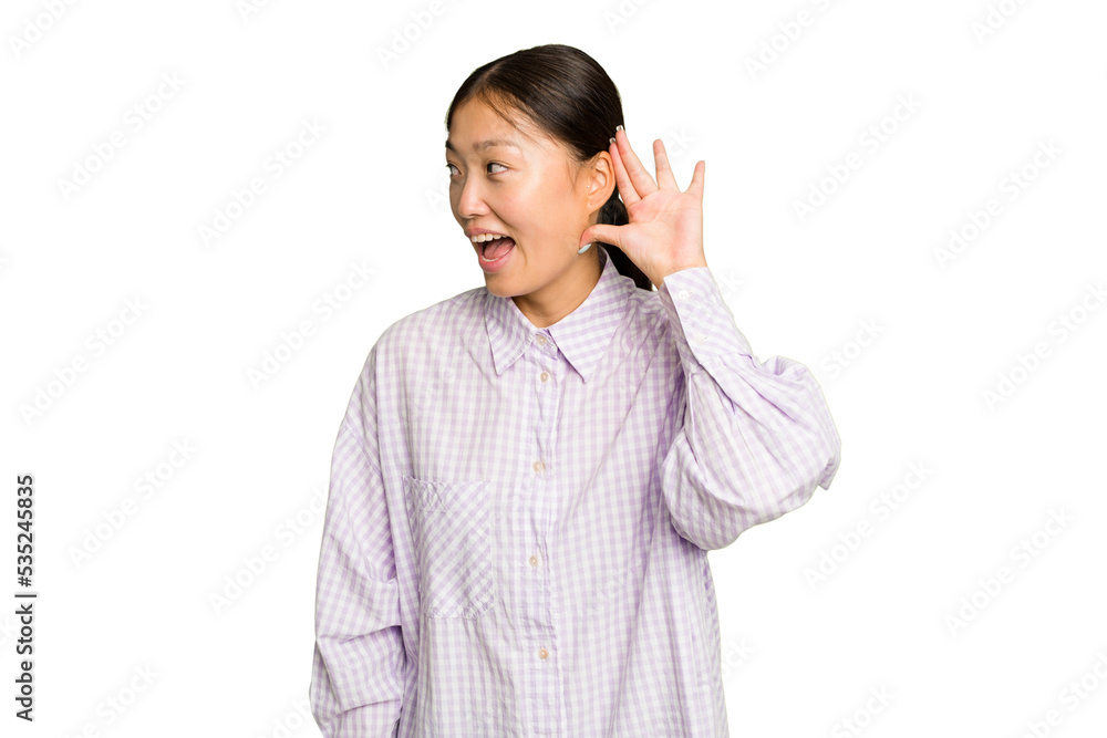 Young Asian woman isolated on green chroma background trying to listening a gossip. Young Asian woman isolated on green chroma background trying to listening a gossip.