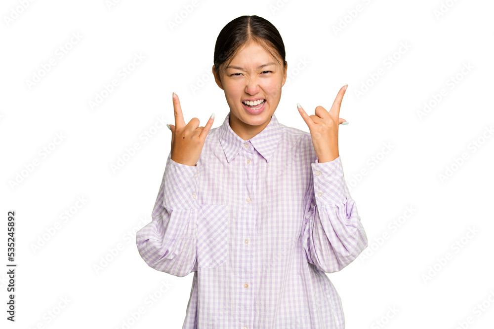 Young Asian woman isolated on green chroma background showing a horns gesture as a revolution concept. Young Asian woman isolated on green chroma background showing a horns gesture as a revolution concept.