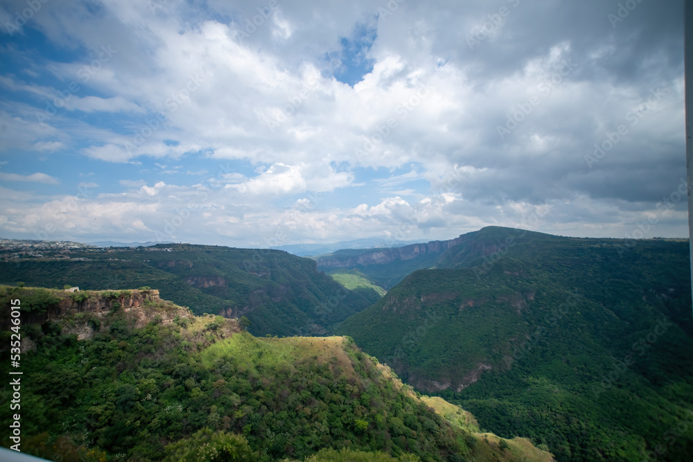 ravine trees and vegetation, view of several mountains at different depths, blue sky and few clouds, mexico ravine trees and vegetation, view of several mountains at different depths, blue sky and few clouds, mexico