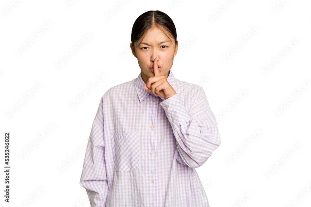 Young Asian woman isolated on green chroma background keeping a secret or asking for silence. Young Asian woman isolated on green chroma background keeping a secret or asking for silence.