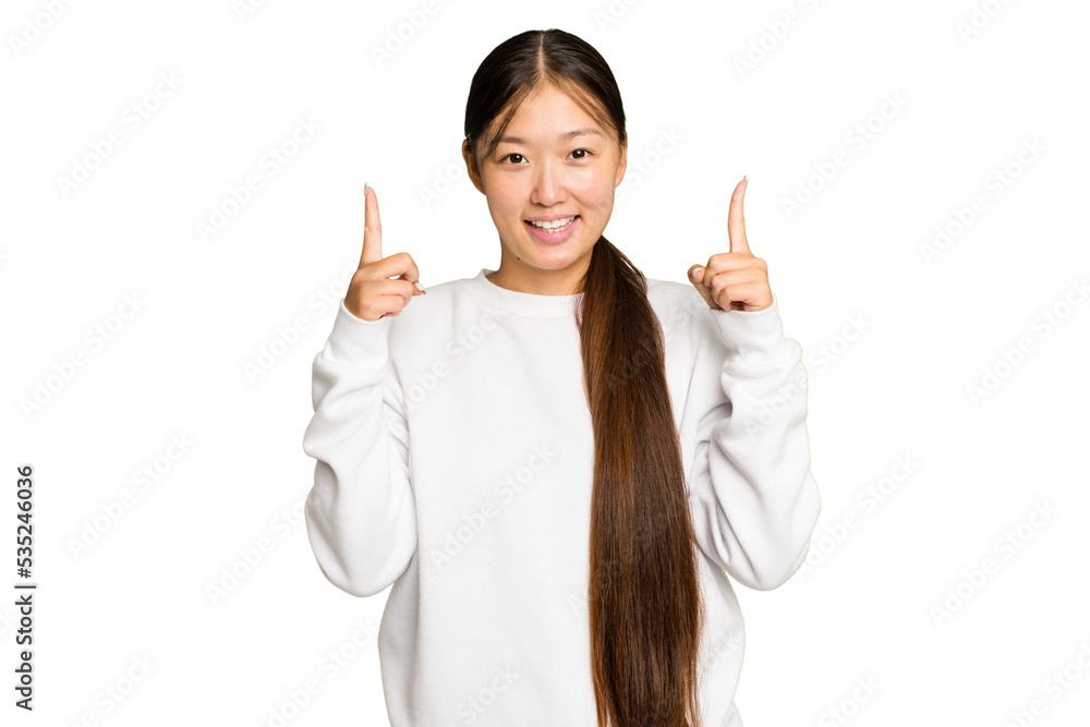 Young Asian woman isolated on green chroma background indicates with both fore fingers up showing a blank space. Young Asian woman isolated on green chroma background indicates with both fore fingers up showing a blank space.
