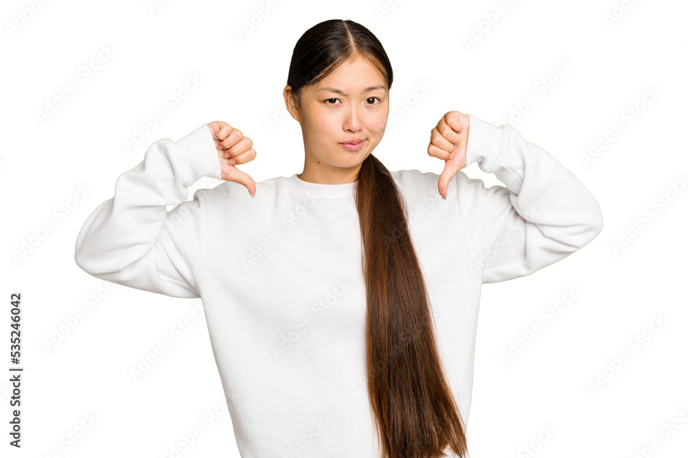 Young Asian woman isolated on green chroma background showing thumb down, disappointment concept. Young Asian woman isolated on green chroma background showing thumb down, disappointment concept.