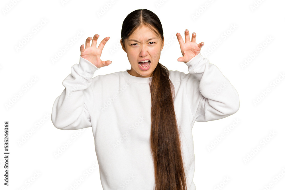 Young Asian woman isolated on green chroma background showing claws imitating a cat, aggressive gesture. Young Asian woman isolated on green chroma background showing claws imitating a cat, aggressive gesture.