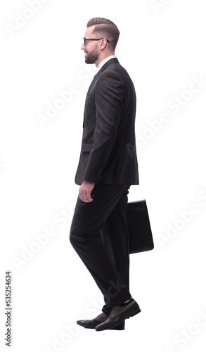 side view . businessman with leather briefcase stepping forward.