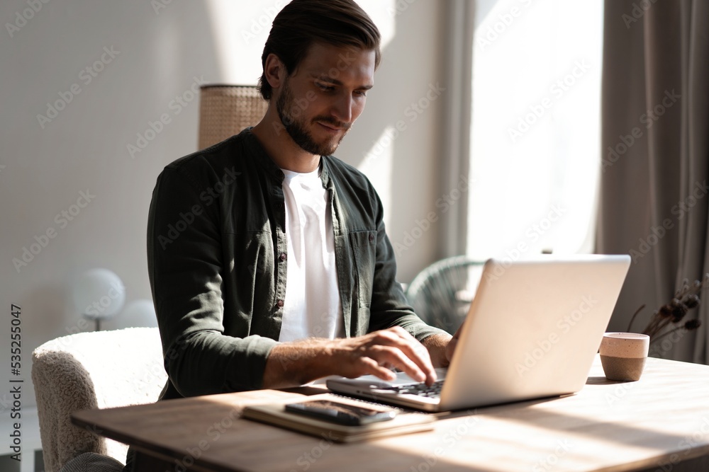 Male remote working from home and having work confrence video call. Freelancer working on laptop at home office. Male remote working from home and having work confrence video call. Freelancer working on laptop at home office.