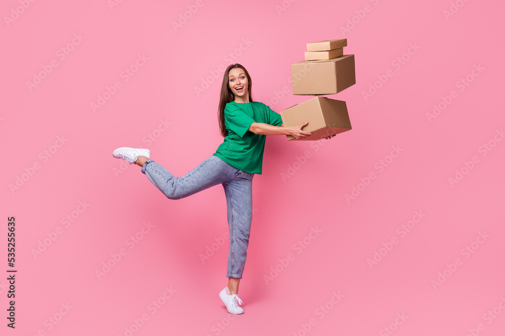 Full length portrait of cheerful crazy person arms hold pile stack packages isolated on pink color background Full length portrait of cheerful crazy person arms hold pile stack packages isolated on pink color background