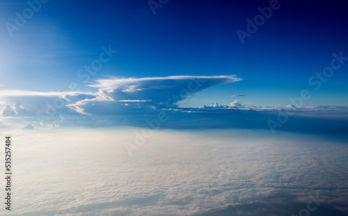 Blue sky and white cloud from airplane window