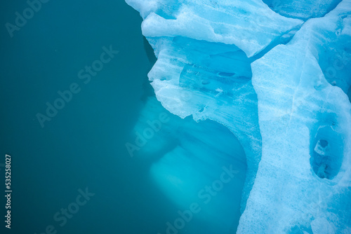 Textured surface of frozen lake with glaciers photo