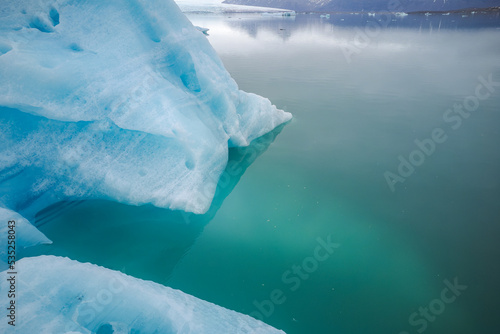 Textured surface of frozen lake with glaciers photo