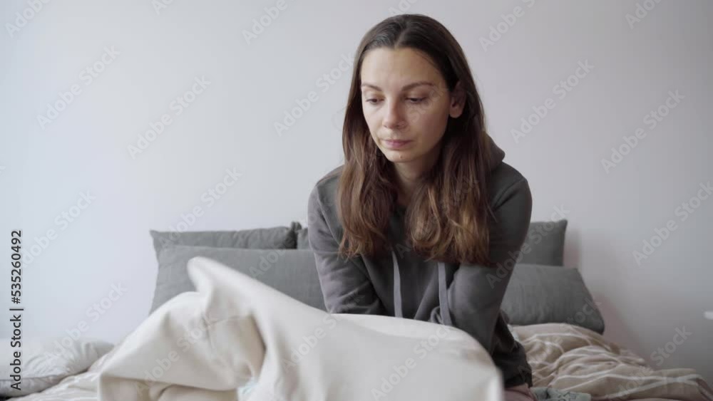 Young woman freezing and dressing up at cold home. Power energy crisis, economy inflation Young woman freezing and dressing up at cold home. Power energy crisis, economy inflation