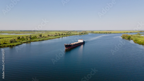 Grain carrier in the sea goes along the Dnieper. Delivery of wheat worldwide. Ship logistics during the war in Ukraine