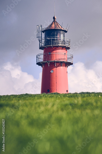 Lighthouse behind a dike at north sea coast in germany. High quality photo