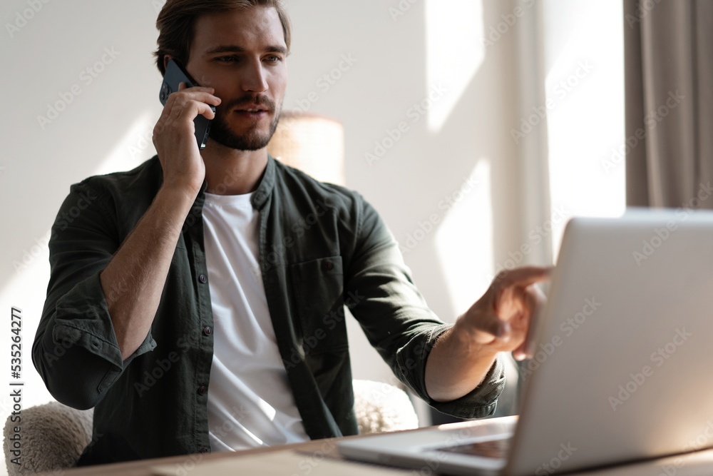 Young businessman talking on phone. Handsome man using his smartphone. Young businessman talking on phone. Handsome man using his smartphone.